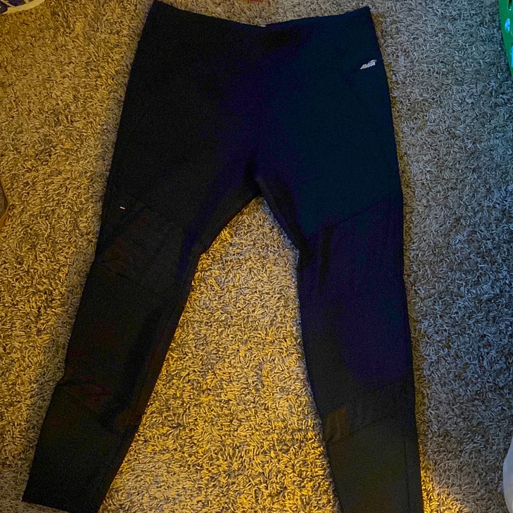 AVIA black leggings. Peak-a-boo at thigh and shin.